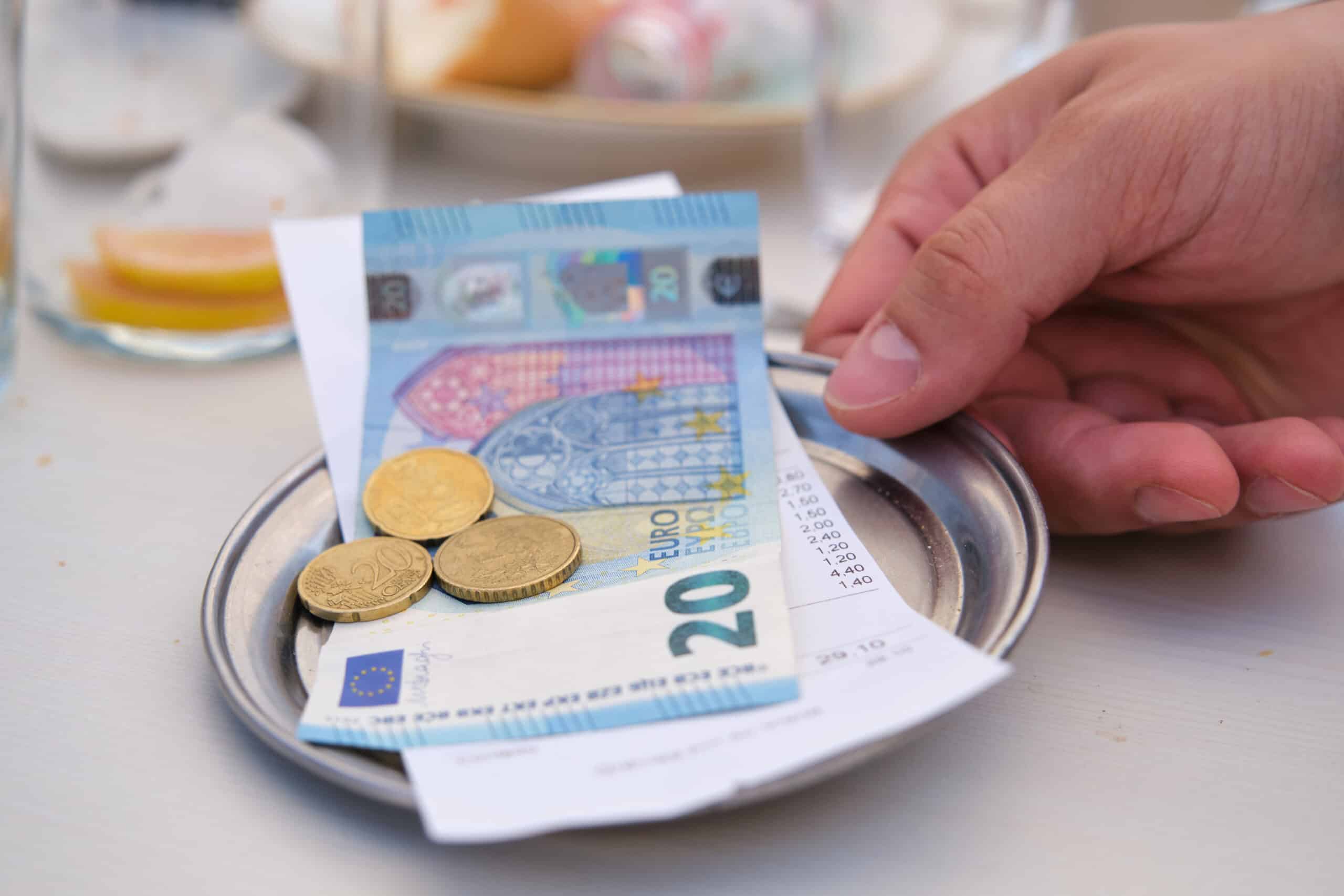 The bill and tip are placed on plate